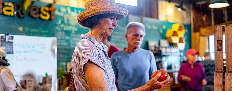 Woman placing an apple into her shopping basket